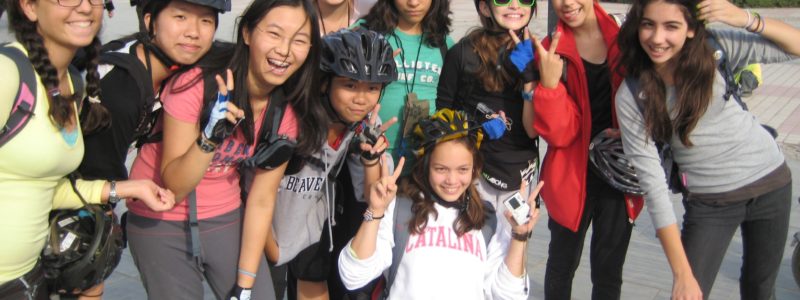 Students in cycling gear posing for a group shot